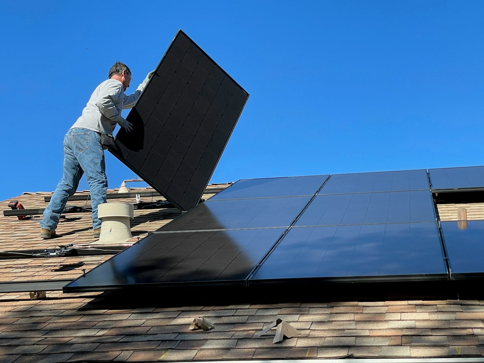 Installer fitting a solar panel